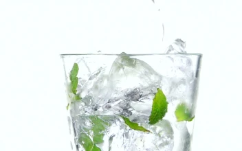 Video Stock Pouring Sparkling Water On A Glass With Mint Leaves And Free