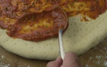Video Stock Preparing A Pizza Dough Covering It With Salsa Free