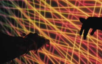 Video Stock Projection With Abstract Neon Lines And A Persons Hand Free