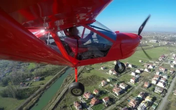 Video Stock Red Aircraft Flying Above The Houses And Landing Free