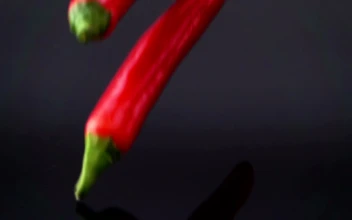 Video Stock Red Chili Pepper Falling Into Black Water Free
