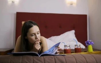 Free Stock Video Relaxed Woman Reading A Book Lying On Her Bed