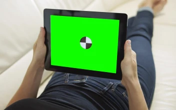 Free Stock Video Relaxing On Sofa Holding Greenscreen Tablet With Chroma Key