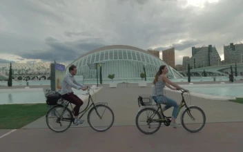 Free Stock Video Riding Bikes Past Modern Buildings