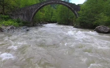 Free Stock Video River Flowing Under An Old Stone Bridge With A Woman