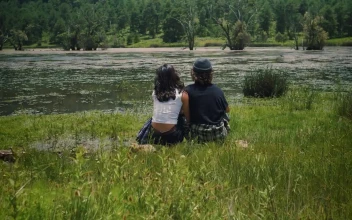 Free Stock Video Romantic Couple Sitting On The Shore Of A Lake