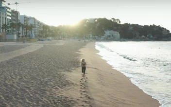 Free Stock Video Running Along A Town Beach