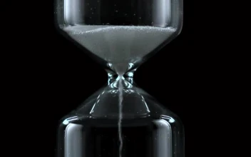 Free Stock Video Sand Falling From An Hourglass On A Black Background