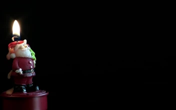 Free Stock Video Santa Claus Shaped Candle On Dark Background