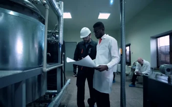Free Stock Video Scientist Walking Through Lab With A Blueprint