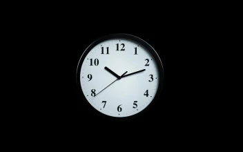 Free Video Stock Slowly Approaching A Clock On A Black Background