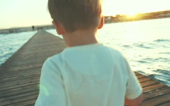 Free Video Stock Small Boy Running Along A Pier