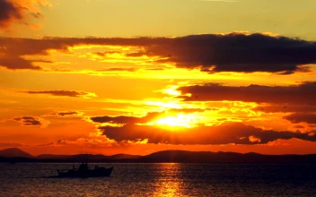 Free Video Stock Small Fishing Boat Crossing The Sunset