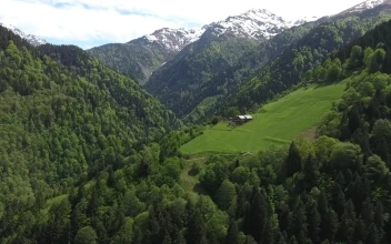 Free Video Stock Small Meadow And A House In The Mountain