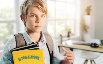 Free Video Stock Smiling Boy Holds English Education Book In Bright Room