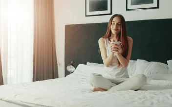 Free Video Stock Smiling Woman Enjoying Morning Coffee In Bed
