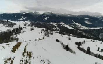 Free Video Stock Snow Covered Hill In A Mountain Range Aerial Shot