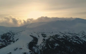 Free Video Stock Snowy Mountain With Pine Trees And Mist Overhead
