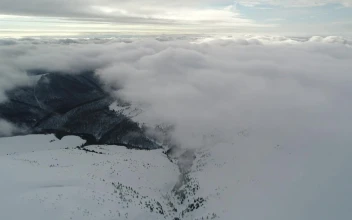 Free Video Stock Snowy Relief Covered By Clouds From Above