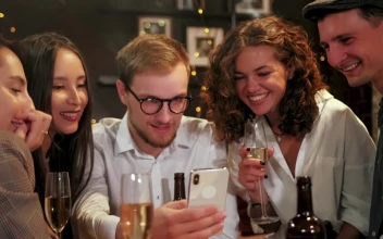Free Video Stock Some Friends Looking At A Cell Phone In A Bar