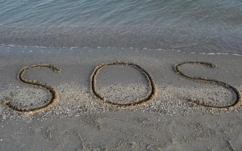 Free Video Stock Sos Written In The Sand On The Shore Of A