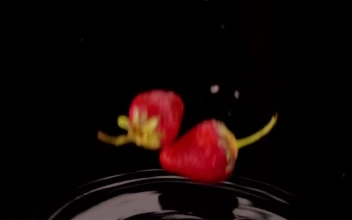Free Video Stock Strawberries Falling Into A Black Water