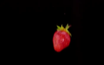 Free Video Stock Strawberries Falling To Black Water