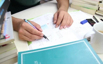 Free Video Stock Student Doing Homework On A Desk With Many Books