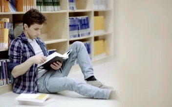 Free Video Stock Student Reading On The Library Corridor