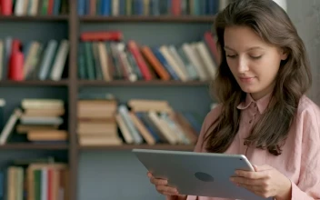 Free Video Stock Student Reading On A Tablet At A Library