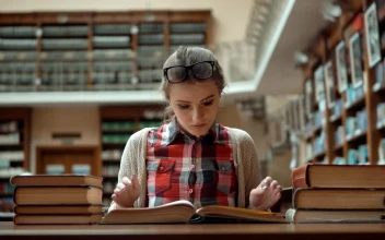 Free Video Stock Student Stressed Over Exam Sits With Books In Library
