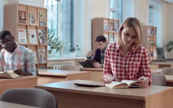 Free Video Stock Student With Book And Tablet In The Library