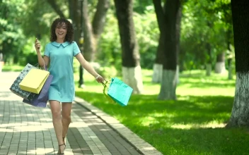 Free Video Stock Stylish Woman Spins With Shopping Bags On Sunny Parkway