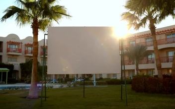 Free Video Stock Sun Flare Behind A Blank Advertisement