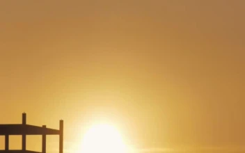 Free Video Stock Sun Hiding Between Hills On The Horizon