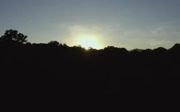 Free Video Stock Sun Setting On The Horizon Of A Mountain Range