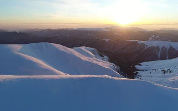 Free Video Stock sunrise on the skyline of a winter mountain range