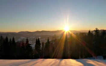 Free Video Stock sunrise sun flare in the snowy mountains