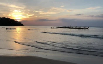 Free Video Stock sunset at a calm beach with boats