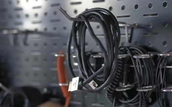 Free Video Stock taking a wire from a tool wall