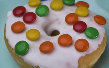 Free Video Stock taking glazed donut with colored chocolates from a plate