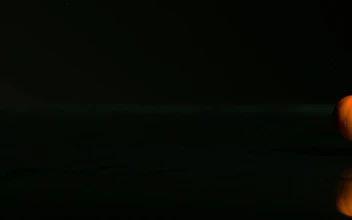 Free Video Stock tangerines rolling on a black surface