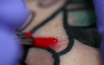 Free Video Stock tattoo artist coloring a tattoo