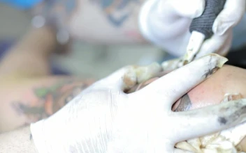 Free Video Stock tattoo artist tattooing a colored flower