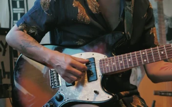 Free Video Stock tattooed man playing an electric guitar