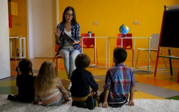 Free Video Stock teacher reading a story to children on a carpet