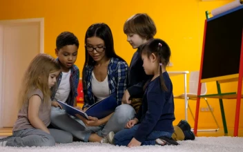 Free Video Stock teacher with some children reading a book together
