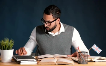 Free Video Stock teacher works at desk in classroom with chalkboard background