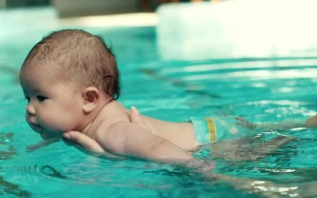 Free Video Stock teaching a baby to swim in the pool