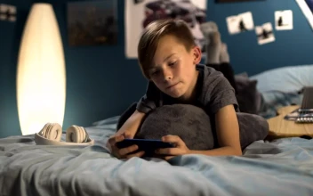 Free Video Stock team bone playing on a smartphone in the bed